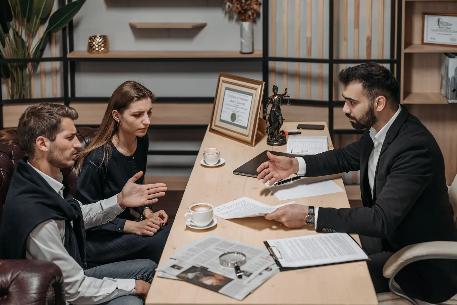 A lawyer explaining documents to two clients