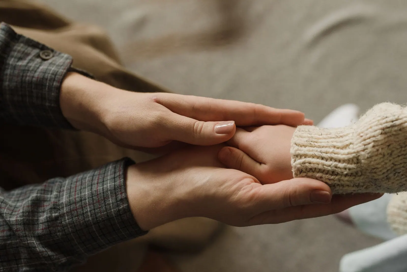 Two hands held together in reassurance