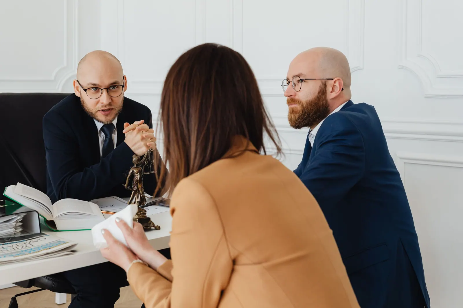 A lawyer in conversation with a client across a desk