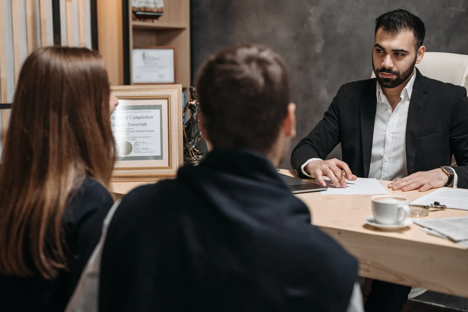 A lawyer advising two clients in an office