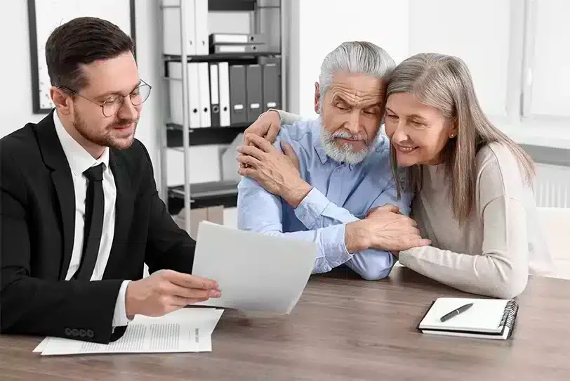 A lawyer reviewing documents with an older couple